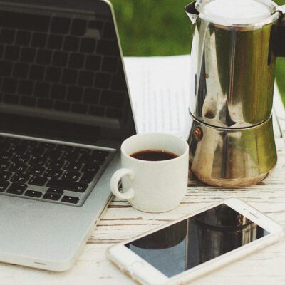 Cup of Coffee Beside a Laptop