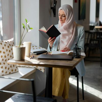 Woman in White Hijab Sitting on Chair